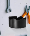 Black Plastic Aerosol Can Holder Wall Mount Organizer with tools on a pegboard