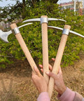 Heavy Duty Gardening Pick Axe With Wooden Handle And Stainless Steel Mattock held in hands, sharp pick and cutting edge visible