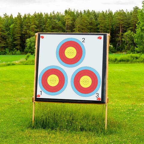 100 Pack Archery Target Paper 3 Spot Targets 17 By 17 Inches With 4 Archery Target Pins on outdoor stand, forest backdrop