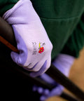 Women Gardening Gloves With Micro Foam Palm Coating And Textured Grip For Weeding Digging Raking And Pruning, holding a garden tool.