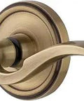 Georgetown Rosette Door Lever Set With Bellagio Lever And Double Dummy In Vintage Brass Finish for interior doors, close-up view.