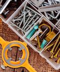 Heavy Duty 2-Piece PVC Thread Die Set For Plumbing Repair beside various screws and bolts in a tool organizer.
