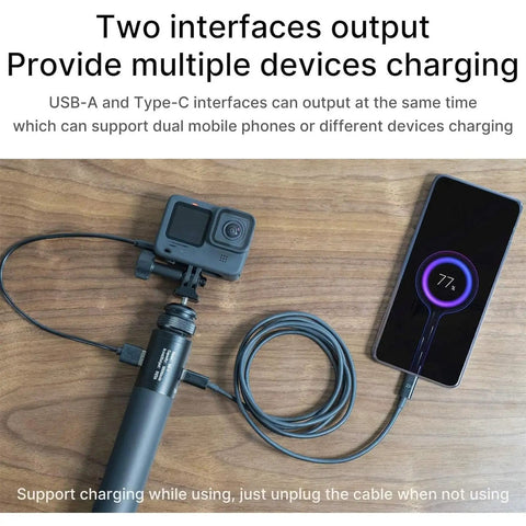 10000mAh Battery Handle Grip For DSLR Action Camera And Smartphone Rig connected to a smartphone and camera on wooden table