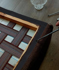 Heavy Duty Black Rubber Upholstery Tack Strip 11 Yard Roll 0.6 Inch Wide Furniture Edge Trim being applied to chair framing.