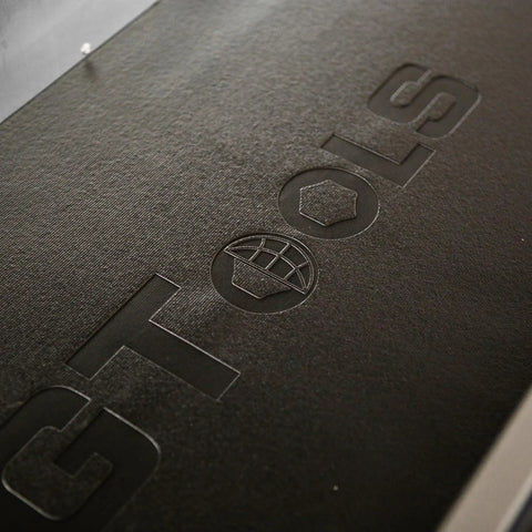Close-up of logo embossed on the top tray of Heavy Duty Steel Rolling Tool Chest With Fourteen Deep Full Extension Drawers And Massive Mega Top Tray.