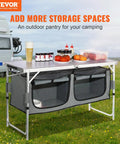 Camping Kitchen Station With Three Adjustable Heights, Folding Outdoor Camp Cooking Table With Storage Organizer on grass.