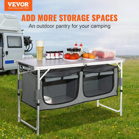 Camping Kitchen Station With Three Adjustable Heights, Folding Outdoor Camp Cooking Table With Storage Organizer on grass.