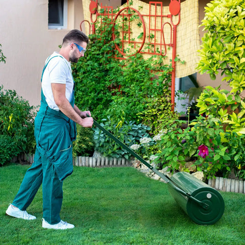 Person using Heavy Duty Lawn Roller Drum For Push Or Tow Behind Tractor, Rust Resistant Powder Coated Metal Frame on grass