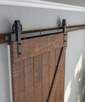 Heavy Duty Seven Point Five Foot Sliding Barn Door Hardware Kit Black With Industrial Bigwheel Hangers installed on wooden door