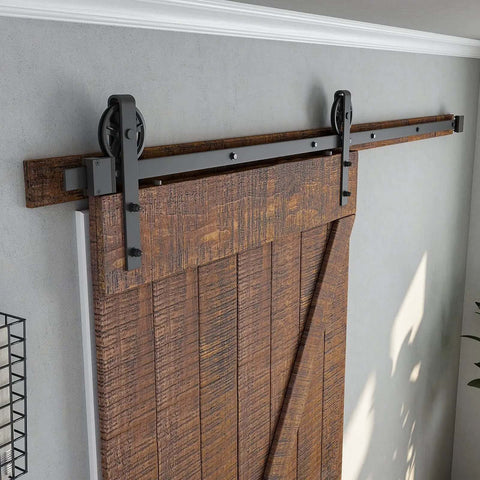 Heavy Duty Seven Point Five Foot Sliding Barn Door Hardware Kit Black With Industrial Bigwheel Hangers installed on wooden door
