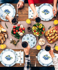 Gathered friends toasting drinks over Awesome Blueberry Party Supplies 200 Piece Disposable Tableware Set for birthday picnics.