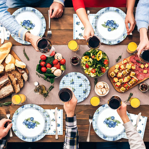 Gathered friends toasting drinks over Awesome Blueberry Party Supplies 200 Piece Disposable Tableware Set for birthday picnics.