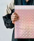 Rose Pink Holographic Padded Mailers 25x30cm Self Seal Waterproof Shipping Bags held by person