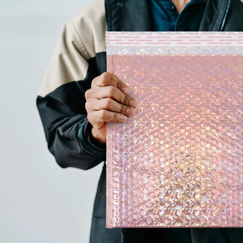 Rose Pink Holographic Padded Mailers 25x30cm Self Seal Waterproof Shipping Bags held by person