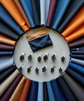 Universal Zipper Repair Kit With 12 Black Replacement Sliders for jackets, jeans, bags arranged in a circle with colorful fabrics.