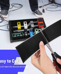 Person cutting Guitar Pedalboard Mounting Tape 2M Long By 50mm Wide With Hook And Loop, ultra-strong adhesive, with scissors.