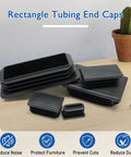 Rectangular Tubing End Caps Four Pack for 2 By 4 Inch Tubes Plastic Black End Plugs on table for metal tubing fences and furniture.