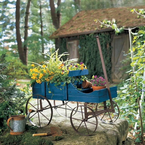 Amish Wagon Garden Planter On Wheels for Indoor Outdoor Decor Blue showcasing flowers, durable wood with iron wheels in a rustic setting