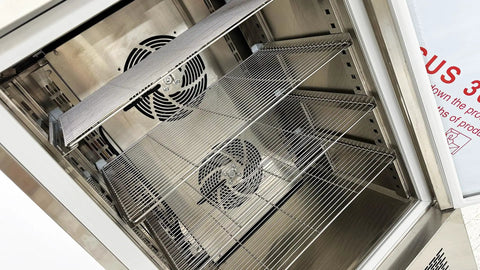 Interior view of Top Shelf Heavy Duty Commercial Blast Freezer 241 Liter Capacity with stainless steel wire shelves and cooling fans.
