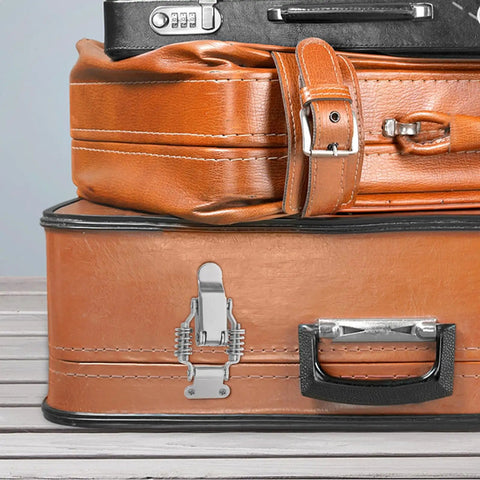 Heavy Duty Iron Toggle Latch Clamp Set Of 4 Shock Absorption Draw Latches For Rv Cabinets Toolboxes And Gear Bags With Secure Locking Mechanism Silver Finish on a leather suitcase.