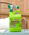 EZ Deck Fence And Patio Wash 64 Oz Mold And Mildew Killer with hose end sprayer on a patio table outdoors