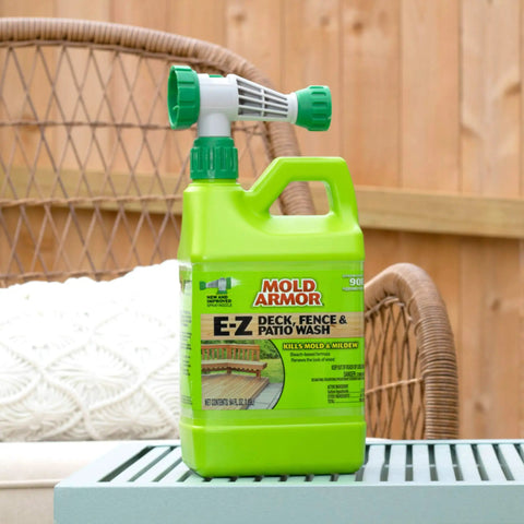 EZ Deck Fence And Patio Wash 64 Oz Mold And Mildew Killer with hose end sprayer on a patio table outdoors