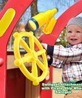 Child playing with Pirate Ship Steering Wheel And Telescopes 3 Pack For Kids Plastic Swingset Accessories in yellow.