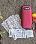 First aid supplies from One Person All-In-One 72 Hour Bug Out Bag Emergency Survival Kit, includes red pouch, bandages, and whistle.