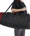 Travelers Club 32-inch expandable rolling duffel bag; black body with red end panel and shoulder strap