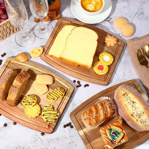 Three acacia wood cutting boards (8x10 in) arranged as serving trays with bread, cheese, and pastries.