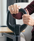 Person using ergonomic safety handle of Adjustable Bamboo Tray Table With Ergonomic Safety Handle And Stand For Couch Or Lap, TV And Laptop Desk, Independent Living Aid, Supports Up To 250 Pounds, Lightweight Portable Bedside Or Living Room Organizer