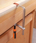 Track F Clamp For 3/8 x 3/4 Double Cut T-Track, 6 Inch Opening, heavy duty, attached to a wooden bench for woodworking use