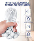 Hand holding Tough As Nails 6 Inch Ball Bungee Cords Set With UV Resistant Elastic Ties and Ball Ends, white cords indoors.