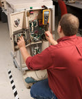 Technician using Pro Grade True RMS Digital Multimeter With Backlit Display And Built-In Temperature Probe on equipment