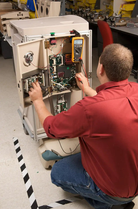 Technician using Pro Grade True RMS Digital Multimeter With Backlit Display And Built-In Temperature Probe on equipment