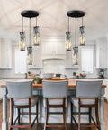 Three Light Black Pendant Light With Crystal Accents, Adjustable Pendant Fixture for Kitchen Island over white cabinets.