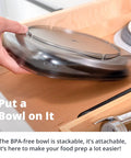 Person placing a BPA-free, stackable bowl lid in a kitchen drawer.