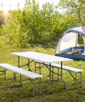 Six Foot Picnic Table Set With Two Benches, Three Piece Folding Outdoor Table And Chair Set For Indoor Or Outdoor Use, smooth white tabletop in a campsite setting.