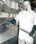 Worker wearing Disposable Coveralls A35 With Hood White 2XL Liquid And Particle Protection Microporous Film Laminated Lightweight PPE Gear Suit For Work 25 Garments Case operating high-pressure cleaner indoors.