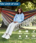 Woman relaxing in Brazilian Style Double Hammock With Fringe For Two People Outdoor Patio Or Indoors Cozy Breathable Fabric