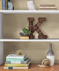 Bookshelf with Cream Tibetan Faux Grasscloth Peel And Stick Wallpaper, showcasing a neutral textured grasscloth look behind decor items.
