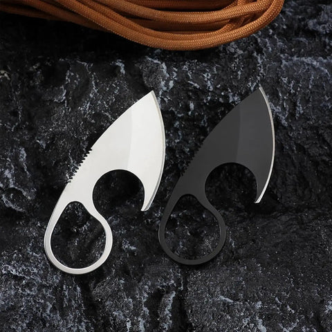 Two small fixed blade EDC knives, white and black, 440C stainless steel, full tang, on stone background, quick access design.
