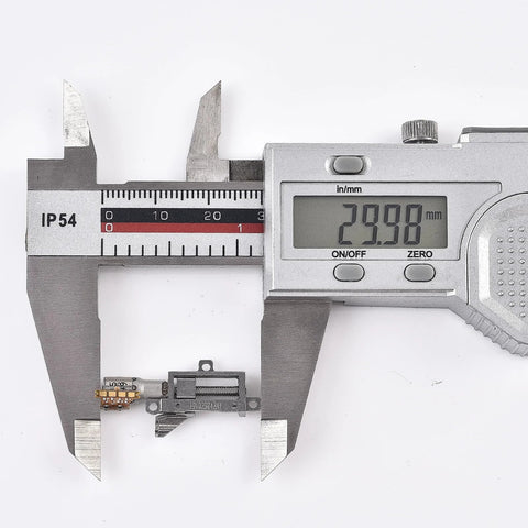 Small metal planetary gearhead lift motor with mounting brackets and orange PCB; caliper reads 29.98 mm