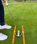 Pocket Size Golf Alignment Sticks And Swing Aid With Modular Ruler System in use on green grass for accurate putting practice.