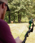 Archer aiming at Bag Target Stand for Indoor and Outdoor Archery Practice Durable Adjustable Bag Holder with Stabilizer Pin in forest