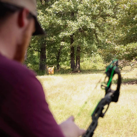Archer aiming at Bag Target Stand for Indoor and Outdoor Archery Practice Durable Adjustable Bag Holder with Stabilizer Pin in forest