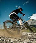 Cyclist riding 26 Inch Fat Tire Mountain Bike With 21 Speed Drivetrain, Dual Disc Brakes, Front Suspension on rough trail