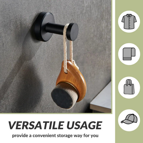 Matte Black Robe Towel Hook With 11 Lb Capacity 304 Stainless Steel Round Heavy Duty Coat Hook, holding a brush