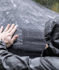 Person applying Heavy Duty Waterproof Repair Tape For Wet And Rough Surfaces Including Underwater Leaks Patching Up Like A Pro Indoors Or Outdoors 2 Inch By 5 Foot Black One Roll on a wet tent.