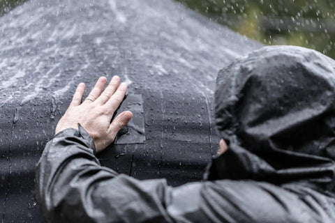 Person applying Heavy Duty Waterproof Repair Tape For Wet And Rough Surfaces Including Underwater Leaks Patching Up Like A Pro Indoors Or Outdoors 2 Inch By 5 Foot Black One Roll on a wet tent.